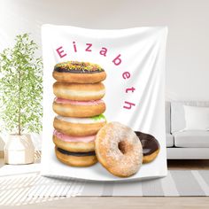 two donuts and one doughnut are stacked on top of each other in front of a white wall