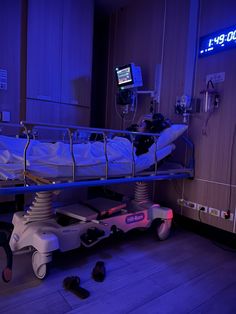 a hospital bed in a room with blue lights