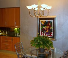 a dining room table with chairs and a potted plant on top of the table