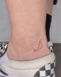 a small tattoo on the ankle of a woman's foot that has a banana