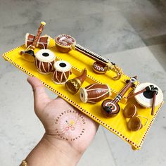 a hand holding a tray with various items on it