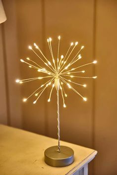 a light up dandelion sitting on top of a table