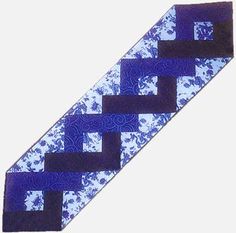 a blue and black tie with an intricate design on the end, in front of a white background