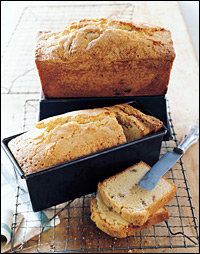 two loafs of bread sitting on top of a cooling rack next to each other