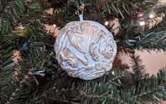 an ornament hanging from the top of a christmas tree