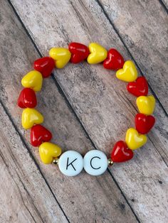 These chunky bracelets are so much fun and the perfect way to show team spirit for ANY Kansas City Chiefs fan! Made from cool red and yellow heart beads, each "KC" or INITIAL is atwix two (2) 18k gold plated round beads. Letter beads are made from silicone and are oversized compared to regular hard plastic letter beads.  Two options to choose from: KC or INITIAL INITIAL - Choose any letter A-Z! *When choosing INITIAL option, please use personalization drop down box and add the letter you would l Personalized Multicolor Bracelets For Team Spirit, Multicolor Team Spirit Bracelets As Gift, Multicolor Team Spirit Bracelets For Gift, Chiefs Bracelet, Plastic Letters, Kc Chiefs, Yellow Heart, Chunky Bracelets, Letter Beads