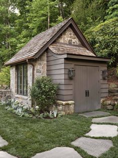 a small shed with a stone walkway leading to it