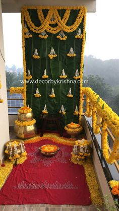 an outdoor stage decorated with yellow flowers and garlands for a wedding or special occasion