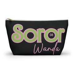 a black cosmetic bag with pink and green lettering that says soror wanda on it