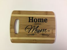 a cutting board with the words home is where your mom is