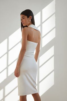 Sleeveless in the City...meet our Manhattan Sleeveless Midi. She's THE dress for both fancy invites or when you just want to look everyday sleek and unique. Fashioned from our soft, mid-stretch European ponte fabric, she features an unforgettable silhouette thanks to her one-shoulder wrap-around neckline and cap sleeve. We hope you're ready for the compliments. [SPLIT] Sam is 5'8" (173 cm) tall, wearing size XS. Total length is approximately 46" (117 cm). European Ponte, also known as Punto di R White Sleeveless Bodycon Dress For Evening, White Bodycon Sleeveless Evening Dress, Sleeveless Sleek Mini Dress In Elastane, Sleeveless Sleek Elastane Mini Dress, Sleek Sleeveless Elastane Mini Dress, Elegant Fitted One-shoulder Halter Dress, Fitted Halter Neck Elastane Dress, Sleeveless Elastane Bodycon Dress For Spring, Sleeveless White Fitted Bodycon Dress