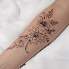 a woman's arm with flowers on it