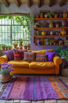 a living room filled with furniture and lots of plants