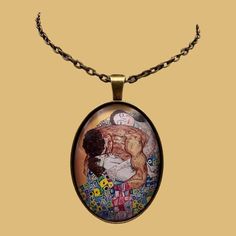 a necklace with an image of a man holding a woman on it's chest