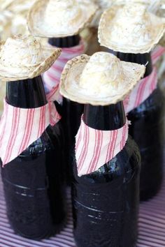 some black bottles with straw hats on them