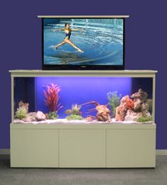 a woman is running in front of an aquarium