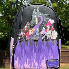 someone is holding a backpack with disney characters on it and flames coming out of the back