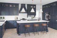 a large kitchen with blue cabinets and white counter tops, two bar stools in front of the island