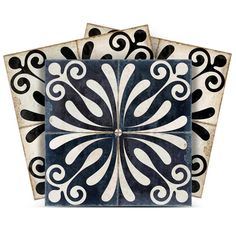 three black and white tiles with swirl designs