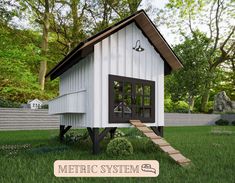 a small white chicken house sitting on top of a lush green field