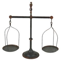 an old fashioned metal balance scale with two swings on one side and the other half