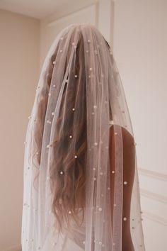 the back of a woman wearing a wedding veil