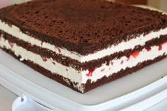 a chocolate cake with white and red toppings on a plate, ready to be eaten