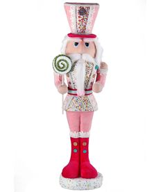 a pink and white nutcracker holding a lollipop