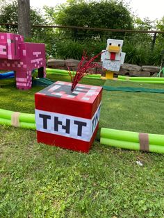 an inflatable box that says thi on it sitting next to some fake animals