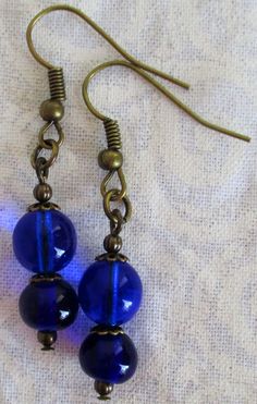 Beaded Dark Blue Drop Earrings 1.5” in length, lightweight earrings in beautiful blues! Made with glass beads and brass-layered ear-hooks and bead caps. These Beaded Dark Blue Drop Earrings will ship to you in a gift box, securely mailed in a padded envelope. Shipping same or next day, thru USPS Ground Advantage, tracking and insurance included. Once mailed, you can track your package at USPS.com. If you don’t love your new treasure, you have 30 days to return it. Go back to Beaded Earrings. Blue Beaded Brass Earrings, Blue Beaded Brass Earrings With Ear Wire, Blue Brass Beaded Earrings With Ear Wire, Blue Dangle Beaded Brass Earrings, Blue Beaded Brass Dangle Earrings, Blue Brass Beaded Dangle Earrings, Blue Beaded Dangle Earrings In Brass, Gift Brass Beaded Earrings With Round Beads, Blue Beaded Brass Earrings As Gift