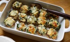 a casserole dish with broccoli and cheese in it on a wooden table