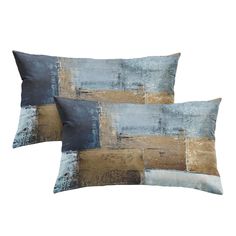 two blue and gold pillows on a white background