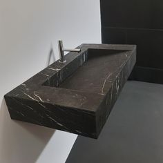 a bathroom sink made out of black marble