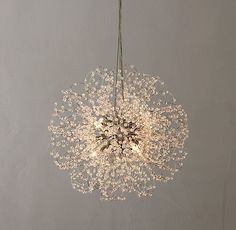 a chandelier hanging from the ceiling in a room with white walls and flooring