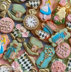 many decorated cookies are arranged on a table with clock and other items in the background