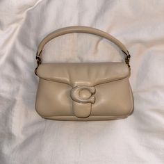 Preloved | Coach Ivory Pillow Tabby 18 Shoulder Bag -Worn 3 Times - Removable Crossbody Strap - Top Flap With Snap Closure - Two Interior Compartments - Interior Slip Pocket - Authenticity Card Included - Leather -Lining: Fabric - Imported Size - Removable Top Handle, 4" Drop - 7.25"W X 4"H X 2.5"D Coach Cream Shoulder Bag, Coach Cream Shoulder Bag With Handle Drop, Coach Beige Shoulder Bag With Zipper Closure, Coach Cream Shoulder Bag With Zipper Closure, Versatile Coach Shoulder Bag With Gold-tone Hardware, Strap Tops, Cream And Gold, Coach Bags, Mini Bag