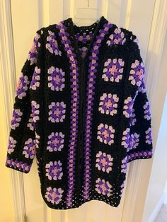 This beautiful purple and black, granny square jacket looks lovely over a purple or black dress. The size is large to extra-large. Long Purple Winter Outerwear, Casual Long Purple Outerwear, Fitted Purple Bohemian Outerwear, Fitted Bohemian Purple Outerwear, Oversized Purple Cardigan For Fall, Oversized Purple Fall Cardigan, Bohemian Black Cardigan With Granny Square, Black Bohemian Cardigan With Granny Square, Purple Bohemian Long Sleeve Sweater