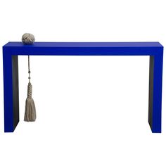 a blue bench with a tasseled ball on it's end and a rope hanging from the top