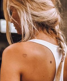 a woman with a heart tattoo on her back