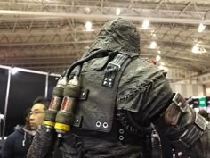 a man dressed as darth vader from star wars standing in a convention hall