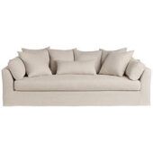 a white couch with several pillows on it's back and one arm facing the camera