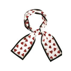 a white scarf with red hearts on it