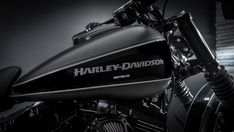 the harley davidson motorcycle is shown in black and white photo, with its logo on it's side