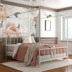 a bedroom with a four post bed and floral wallpaper on the walls behind it