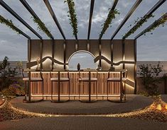 an outdoor bar is lit up at night with lights on the top and below it