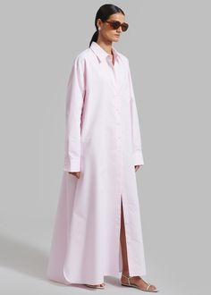 Color: Petal Midweight fluid cotton fabric Oversized fit Maxi length Pointed collar Drop shoulders Button cuffs Single patch breast pocket High side seam slits Partial front button down closure Unlined 60% Cotton 40% Polyester Dry Clean By The Frankie Shop. Imported Chic Long Sleeve Cotton Shirt Dress, Spring Cotton Shirt Dress With Spread Collar, Cotton Shirt Dress With Button Cuffs For Daywear, Shirttail Hem Shirt Dress For Daywear, Chic Cotton Shirt Dress With Pockets, Shirt Dress With Placket And Shirttail Hem For Daywear, Classic Oversized Shirt Dress With Spread Collar, Classic Oversized Shirt Dress With Button Cuffs, Oversized Classic Shirt Dress With Placket