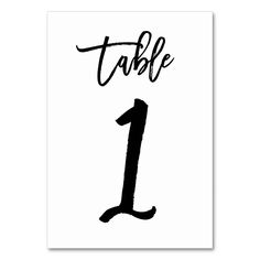 a black and white table number one with the word table written in cursive writing