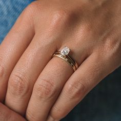 a woman's hand with a ring on it and a diamond in the middle