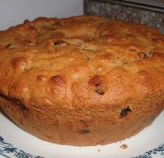 a cake sitting on top of a white plate next to a blue and white bowl