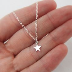 ALL STERLING SILVER - A GREAT KEEPSAKE This celestial necklace is lovingly hand-made with all solid sterling silver parts, making it a thoughtful gift (even for yourself!). A tiny shiny star dangles elegantly from the sparkly chain. Closes with an easy-to-use spring clasp. Star charm measures approximately 1/4 inch tall. Comes in a gift box, perfect for gift-giving. **SIZING - PLEASE READ: Select your necklace size at checkout. Note that necklaces will fit differently depending on a person's siz Everyday Celestial Sterling Silver Charm Necklaces, Minimalist Star Charm Necklaces For Gift, Silver Star-shaped Dainty Jewelry, Minimalist Star Charm Necklace Gift, Personalized Star-shaped Sterling Silver Jewelry, Silver Star Charm Necklaces In Celestial Style, Silver Star Charm Necklace In Celestial Style, Sterling Silver Star Charm Necklace For Everyday, Silver Star-shaped Celestial Charm Necklaces